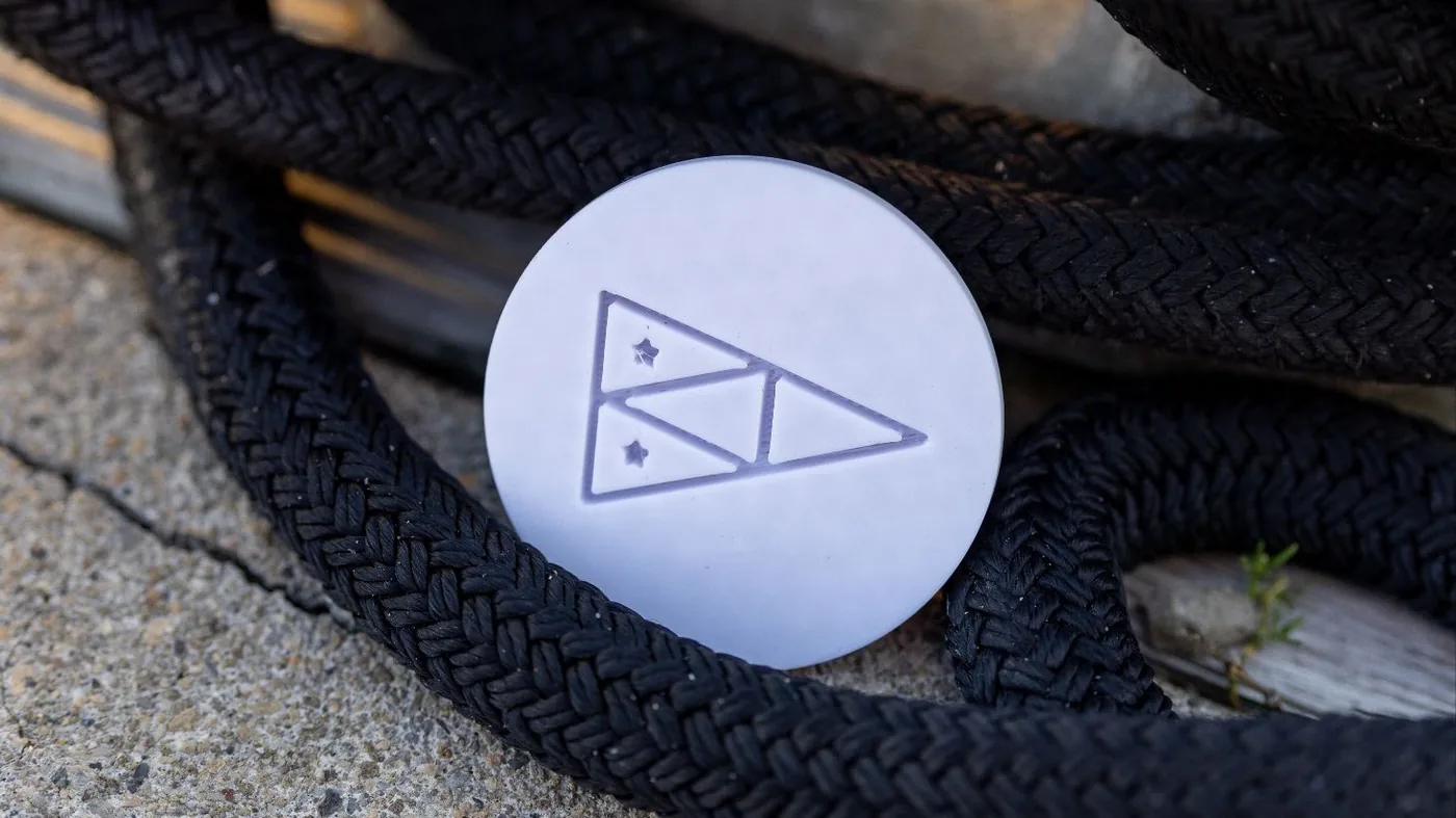 A white ProPlug resting on a coil of black line.